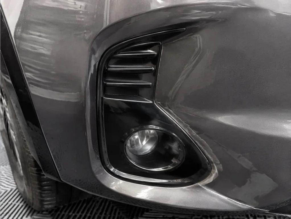 Bumper wrap before correction: edge lift, silvering, and trapped air in recess